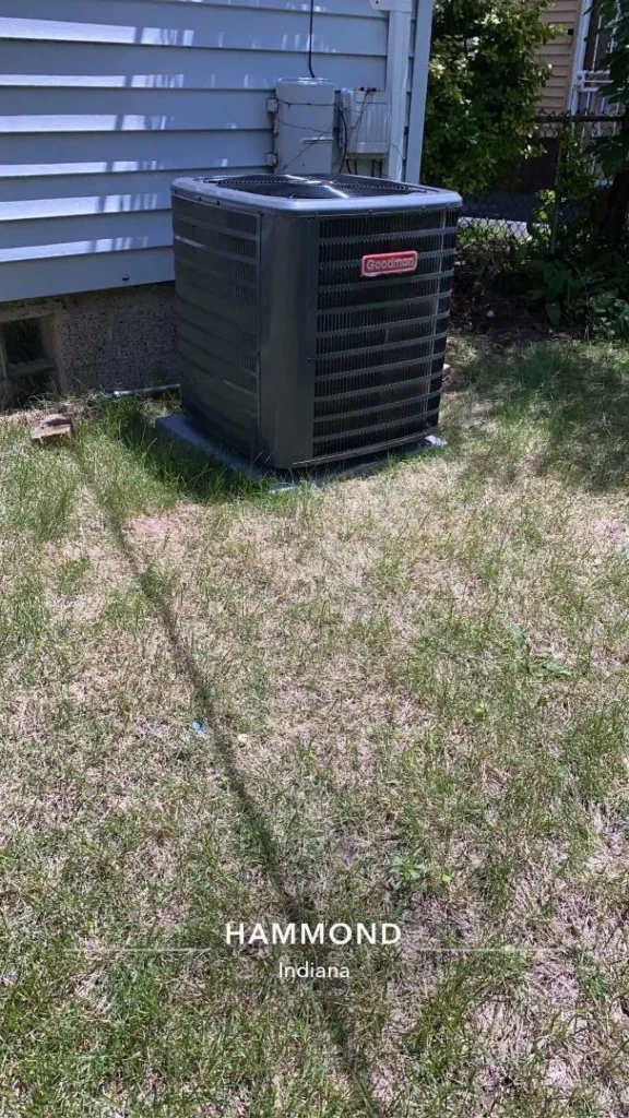 A new Goodman condenser on a pad in a back yard in Hammond