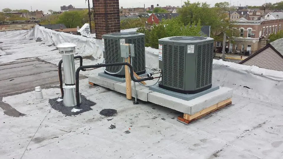 Two condensers Diego installed on a flat commercial roof